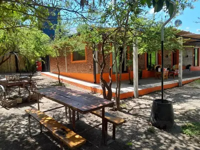 a picnic table and a bench in front of a building at La Casa De Mi Viejo in San Javier