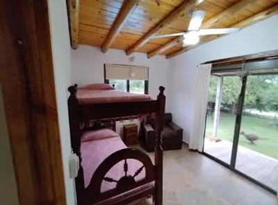 a bedroom with two bunk beds and a sliding glass door at La Casa De Mi Viejo in San Javier