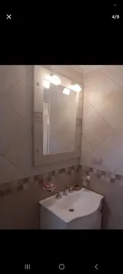a bathroom with a white sink and a mirror at Dpto 22 in Villa Carlos Paz