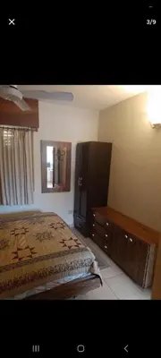 a bedroom with a bed and a dresser and a mirror at Dpto 22 in Villa Carlos Paz