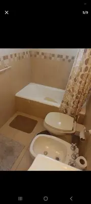 a bathroom with a toilet and a sink and a tub at Dpto 22 in Villa Carlos Paz