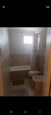 a bathroom with a tub and a toilet and a sink at Dpto 22 in Villa Carlos Paz