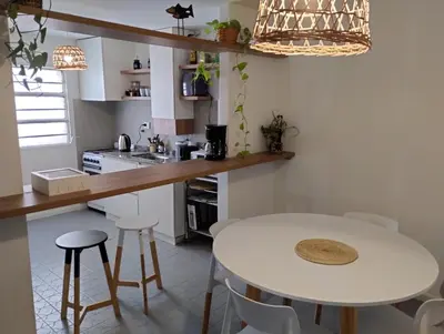 a kitchen with a white table and some stools at Great Lofty in Cordoba