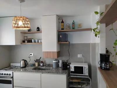 a small kitchen with a stove and a microwave at Great Lofty in Cordoba