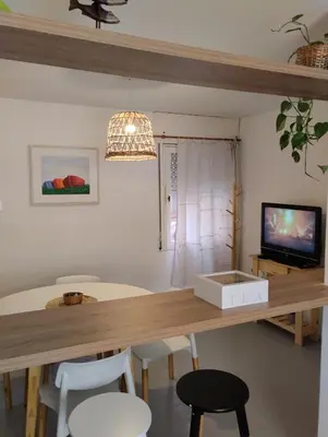 a dining room with a table with chairs and a television at Great Lofty in Cordoba