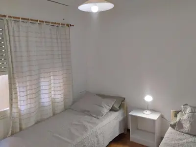 a bedroom with two beds and a window at Great Lofty in Cordoba
