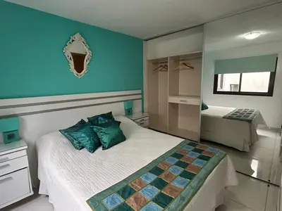 a bedroom with a bed and a blue wall at Departamento Libertad in Villa Carlos Paz
