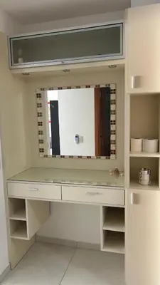 a dressing table with a large mirror in a room at Departamento Libertad in Villa Carlos Paz