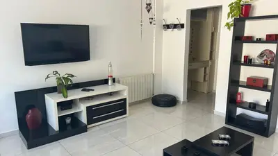 a living room with a flat screen tv on a wall at Departamento Libertad in Villa Carlos Paz
