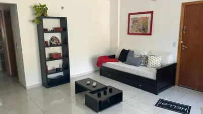 a living room with a couch and a table at Departamento Libertad in Villa Carlos Paz