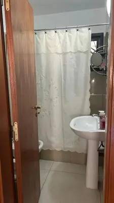 a bathroom with a sink and a shower curtain at Departamento Libertad in Villa Carlos Paz