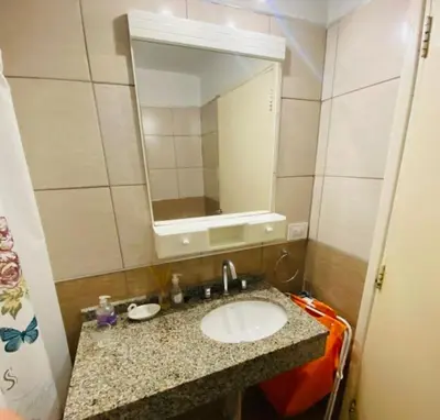 a bathroom with a sink and a mirror at Departamento Centrico Eutico in Villa Carlos Paz