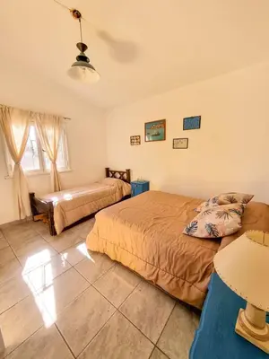 a bedroom with two beds and a window at Casa Ramona in Embalse