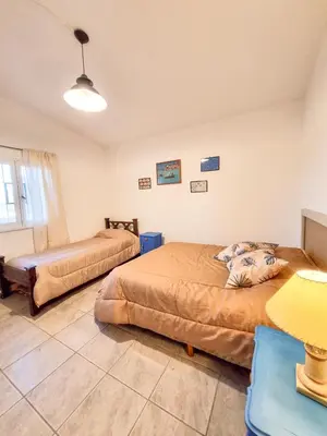 a bedroom with two beds and a table at Casa Ramona in Embalse