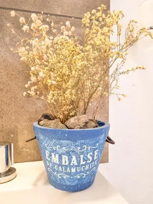 a blue vase with flowers in it sitting on a table at Casa Ramona in Embalse