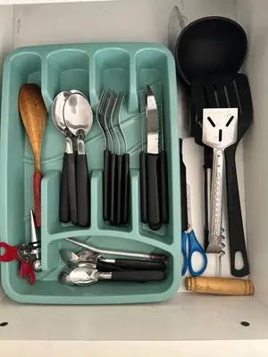 a plastic container filled with utensils on a counter at Urban Alberdi Dpto con cochera, pileta y seguridad 24 hs in Cordoba
