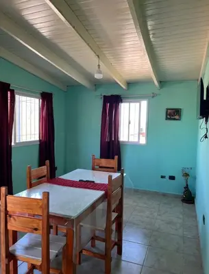 a dining room with a table and chairs at Villa Dolores - Departamento