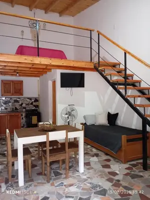 a living room with a bed and a loft at Cabañas KAIZEN in Santa María