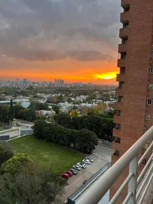 a view of a city with cars parked in a parking lot at Departamento Atardecer de Rio Cuarto in Río Cuarto