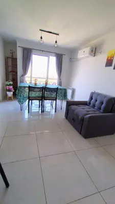 a living room with a couch and a table at Departamento Atardecer de Rio Cuarto in Río Cuarto