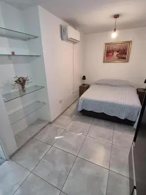 a bedroom with a bed and a tiled floor at Dpto Cordoba in Cordoba