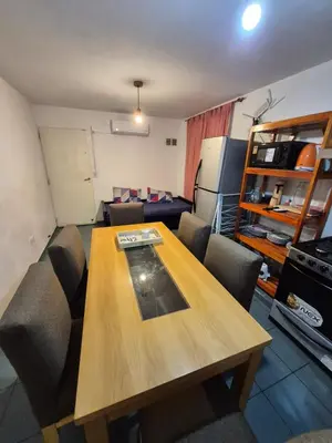 a living room with a wooden table and chairs at Dpto Cordoba in Cordoba