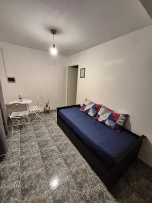 a room with a bed and a table in it at Dpto Cordoba in Cordoba