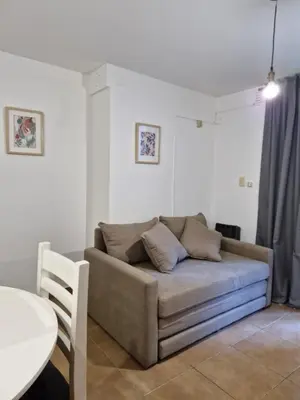 a living room with a couch and a table at Alberdi Urban Suite in Cordoba