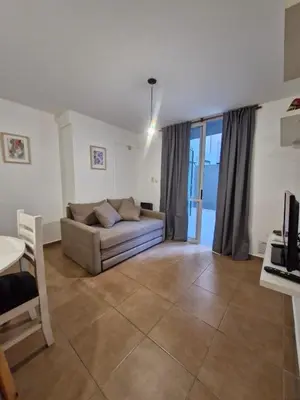 a living room with a couch and a table at Alberdi Urban Suite in Cordoba
