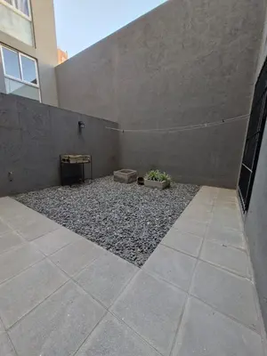 a courtyard of a building with a concrete wall at Alberdi Urban Suite in Cordoba