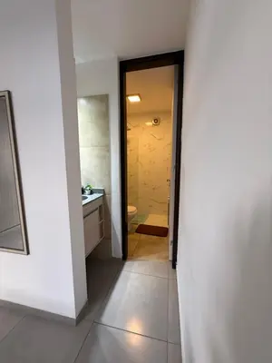 a hallway leading to a bathroom with a sink at Departamento premium con amplio patio en pleno centro de Carlos Paz in Villa Carlos Paz