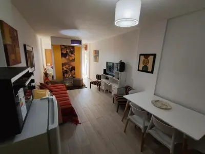 a living room with a table and chairs and a living room at I rent an apartment in the center of Cordoba Capital in Cordoba