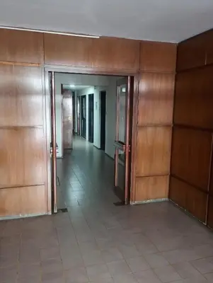 an empty hallway with wood paneled walls and doors at I rent an apartment in the center of Cordoba Capital in Cordoba