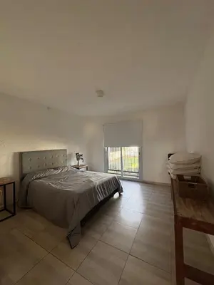 a bedroom with a bed and a large window at Casa Guemes, pet friendly in Villa Carlos Paz
