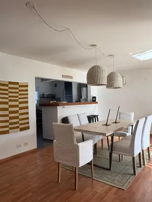 a dining room with a table and chairs at Casa Guemes, pet friendly in Villa Carlos Paz