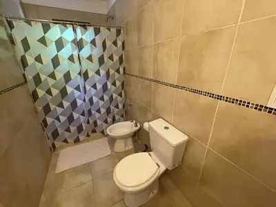 a bathroom with a toilet and a shower at Complejo Don H in Villa Carlos Paz