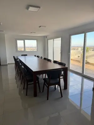 a conference room with a long table and chairs at departamento en edificio torre libertador in Río Tercero