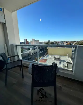a room with a balcony with a view of a city at departamento en edificio torre libertador in Río Tercero