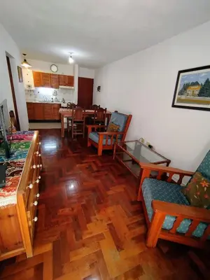 a living room with wooden floors and a dining room at Departamento en zona centro La Cañada para 2 personas in Cordoba