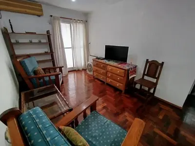 a living room with a television and a couch and chairs at Departamento en zona centro La Cañada para 2 personas in Cordoba