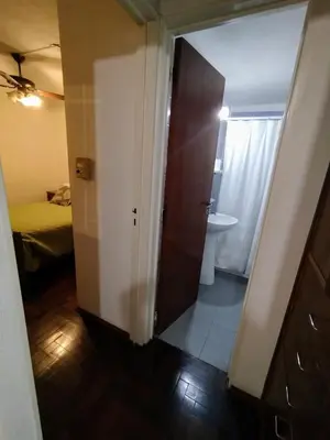 a room with a door leading to a bathroom with a sink at Departamento en zona centro La Cañada para 2 personas in Cordoba