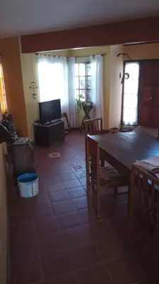 a dining room with a wooden table and chairs at Abrazo del Sol in Villa Santa Cruz del Lago