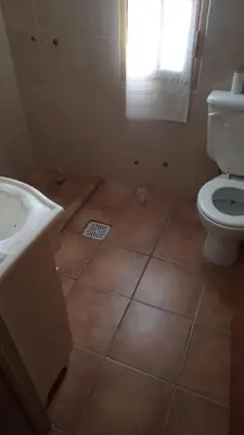 a bathroom with a toilet and a sink at Abrazo del Sol in Villa Santa Cruz del Lago