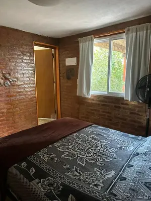 a bedroom with a bed and a window at Ludqui in Villa Rumipal