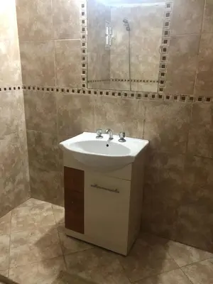 a bathroom with a sink and a mirror at Ludqui in Villa Rumipal