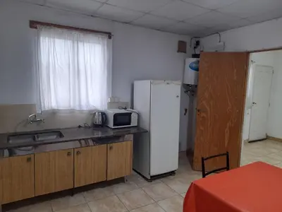 a kitchen with a white refrigerator and a microwave at Alquiler de departamento por dia in Río Cuarto