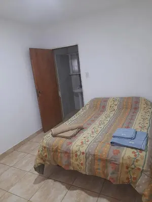 a bed in a bedroom with two blue towels on it at Alquiler de departamento por dia in Río Cuarto