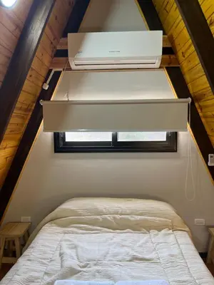 a bedroom with a bed in a tiny house at Aire Escondido in Villa Berna