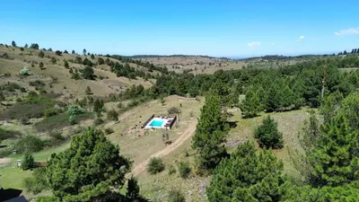 an aerial view of a house on a hill with a pool at Aire Escondido in Villa Berna