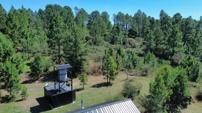an object sitting on top of a field with trees at Aire Escondido in Villa Berna